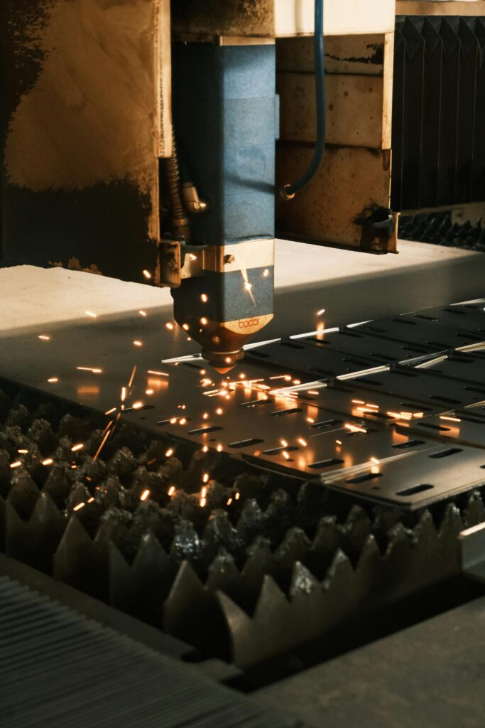 pexels-photo-29988985-29988985 Close-up of a laser cutter in action, producing sparks in a modern manufacturing facility.